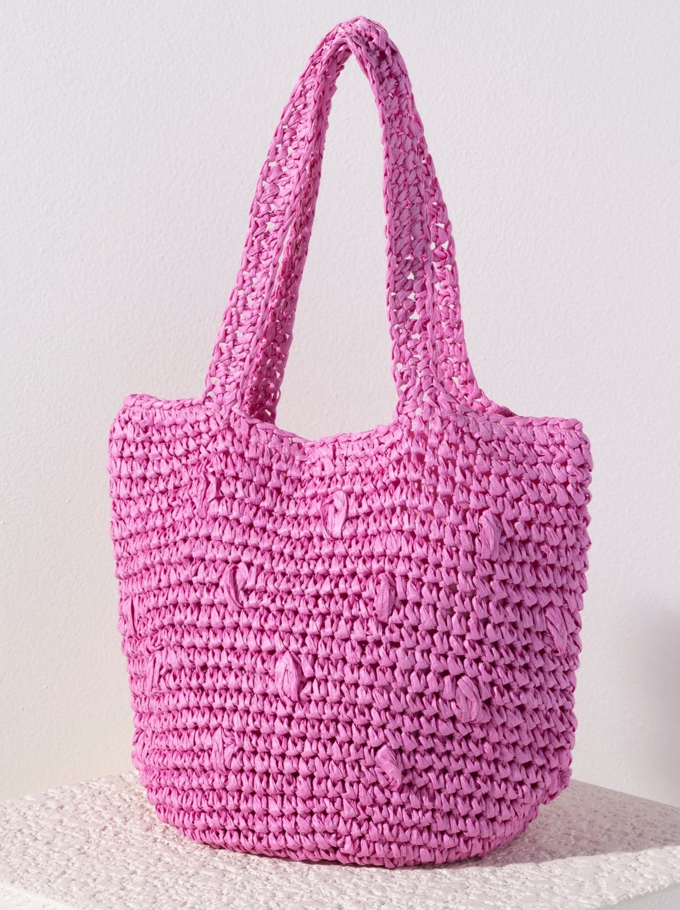Carry your essentials in style this summer with Shiraleah's Sam Tote. Made from woven paper straw with two sturdy handles, this trendy tote bag is both practical and stylish. The bright green design adds a classic color pop to any summer outfit. Pair with other items from Shiraleah to complete your look!
