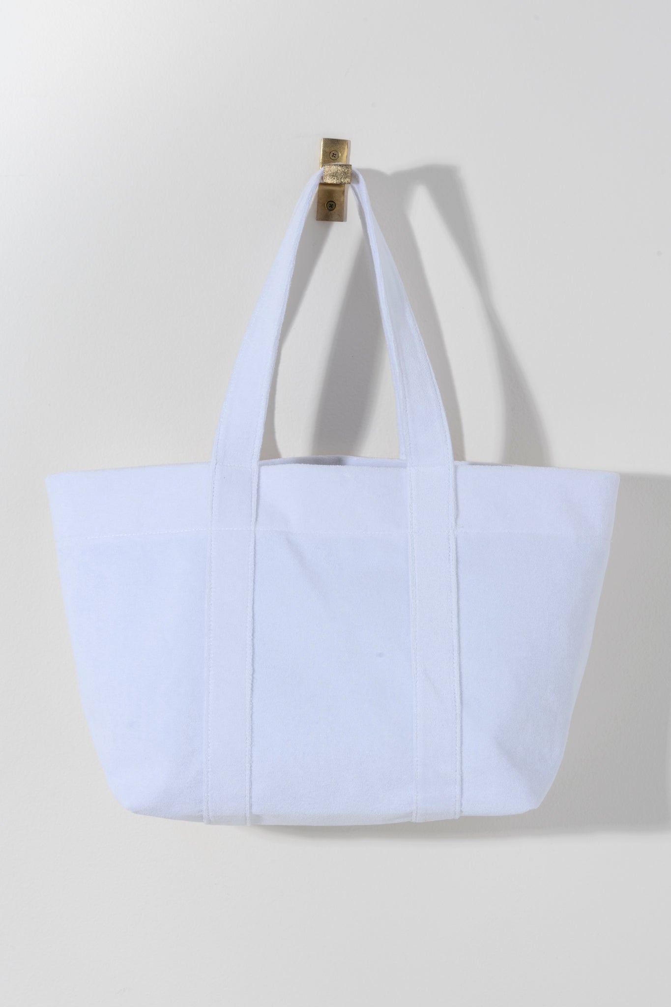 Say hello to your honeymoon with Shiraleah's Sol "Bride" Tote. Made from soft and absorbant cotton terry, this chic white tote can carry all of your pool or beachside essentials. Its chic gold embroidered inscription of the word "Bride" makes it a perfect gift for your favorite finacee. Pair with other items from Shiraleah's Hitched collection to complete your look!