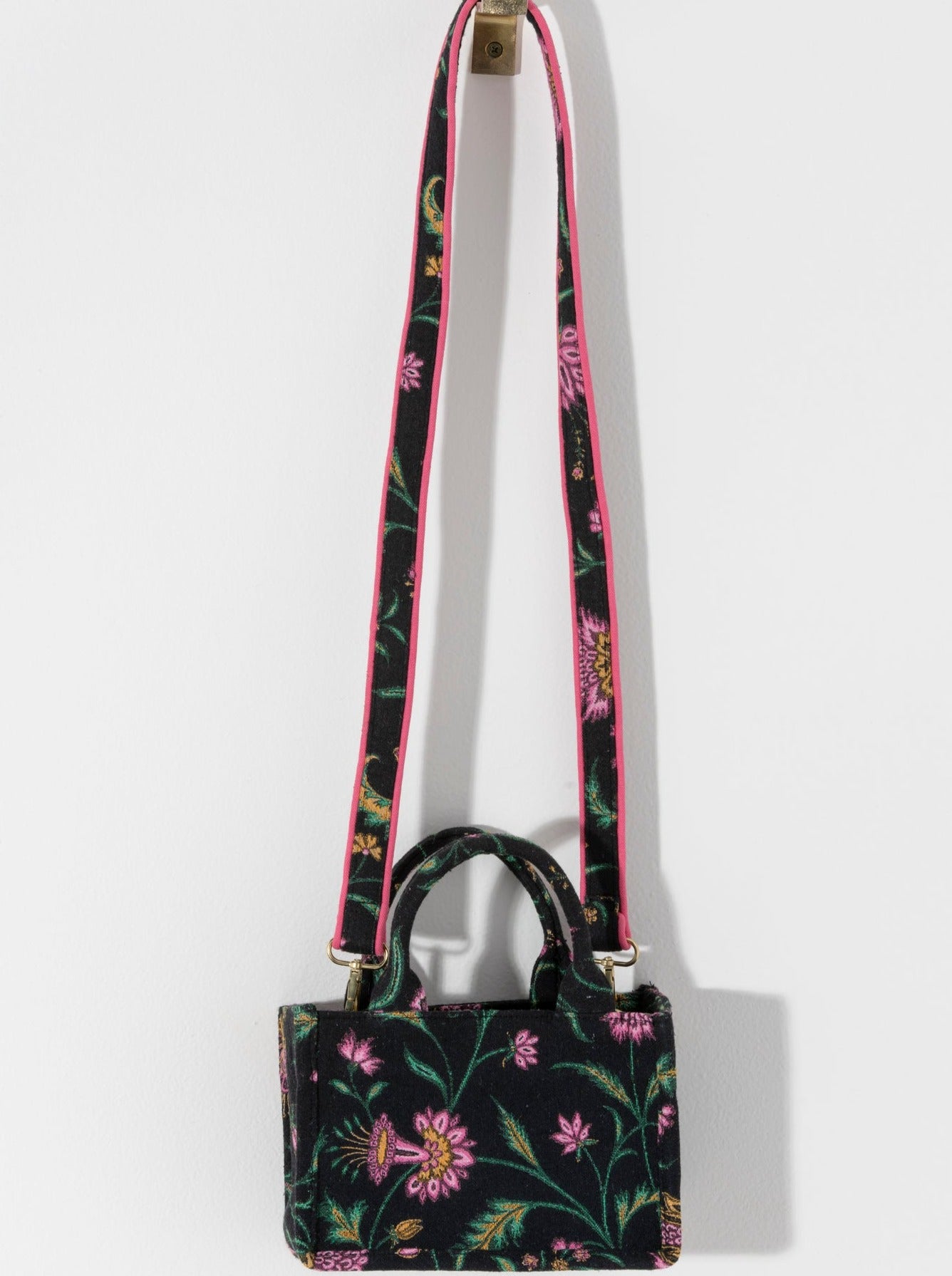 Carry your summer essentials in style with Shiraleah's Luma Mini Tote. This soft but structured canvas bag features a stylish pink and yellow floral design. With double handles and a matching detachable cross-body strap, there are endless ways to wear this purse. Pair with other Shiraleah items to complete your look!