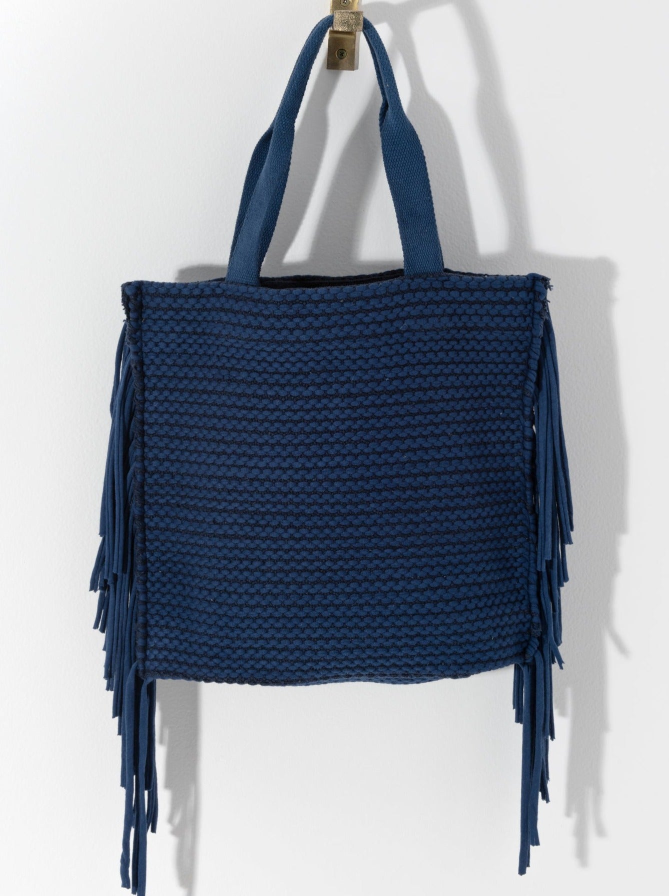 Show off your playful side this season with Shiraleah's Mavis Tote. Lined with long tails of fringe, this dynamic bag will draw eyes anywhere you go. With double shoulder straps and a roomy interior, you'll be set to carry all your essential items all summer long. Pair with the Mavis Zip Pouch and other items from Shiraleah to complete your look!