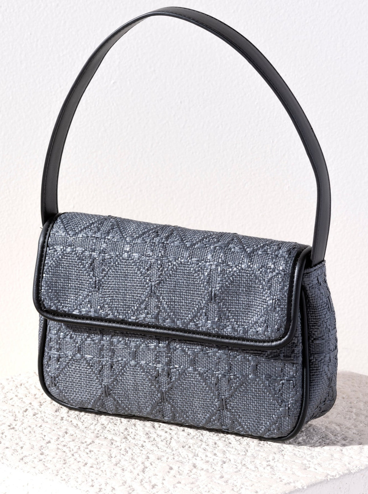 Spruce up your summer wardrobe with Shiraleah's Arienne Baguette. Made from trendy raffia fabric in a sleek baguette silhouette, this bag will be your favorite accessory of the summer. Its single shoulder strap and compact size make it the perfect addition to every outfit. Pair with other items from Shiraleah to complete your look!