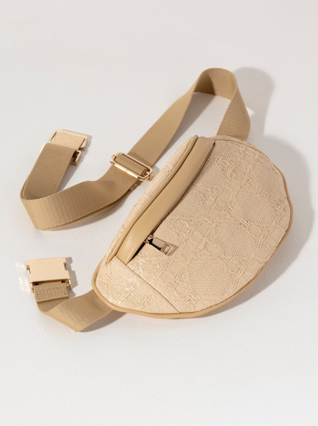 Keep everything you need right in reach with Shiraleah's Adrienne Belt Bag. Made from trendy raffia fabric with gold hardware, this bag can wrap around your waist or be slung fashionably across the body. The neutral color scheme allows this bag to work with any of your favorite summer outfits. Pair with other items from Shiraleah to complete your look!