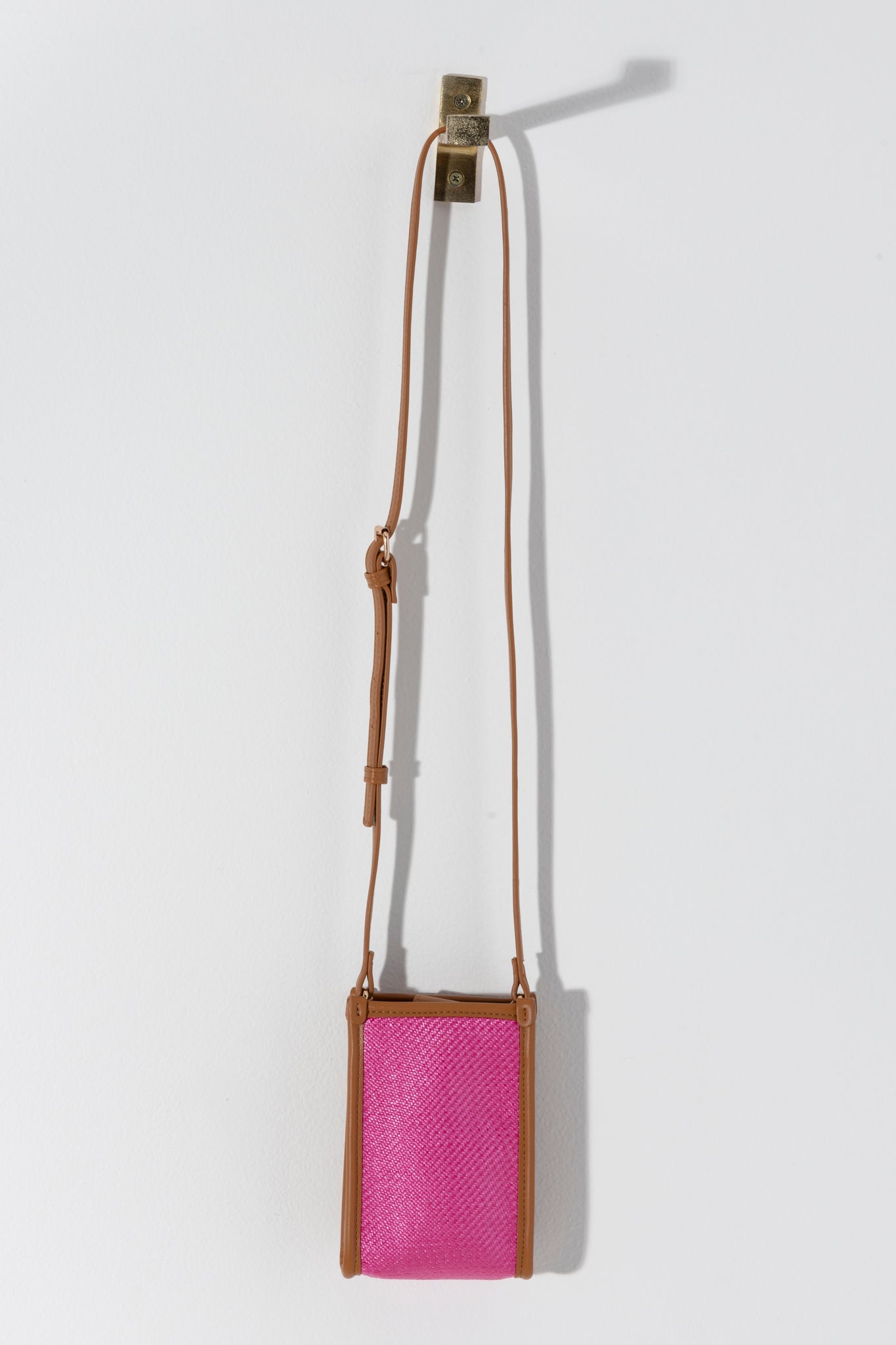 Never forget your phone again with Shiraleah's Piper Phone Holder. Available in a variety of colors, this timeless piece is as classically elegant as it is practical. With an adjustable cross-body strap, this phone holder is large enough for your smartphone and even has spots for your ID and three credit cards. Pair with other items from Shiraleah to complete your look!