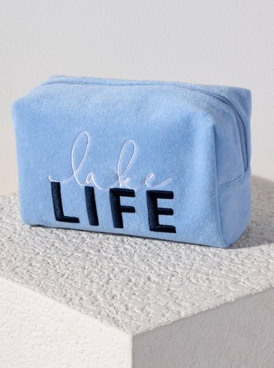 Carry all your odds and ends in style with Shiraleah's Sol "Lake Life" Zip Pouch. Made from soft and absorbent cotton terry with a PVC inner lining, this pouch is a perfect companion for the poolside or on the go. Its trendy embroidery of the words "Lake Life" makes it a fun addition to your summer wardrobe. Pair with other items from Shiraleah to complete your look!