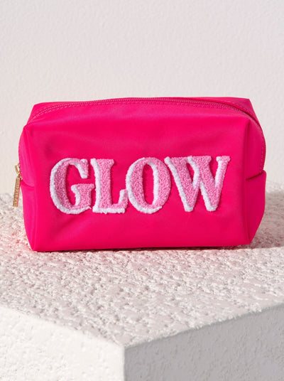 Carry all your odds and ends in style with Shiraleah's "Glow" Zip Pouch. Made of durable polyester in a vibrant pink, this rectangular case can fit inside of a larger zip pouch while still providing plenty of room inside. The trendy toothbrush embroidery spells the word "Glow" in light pink and white lettering. Pair with other items from Shiraleah to complete your look!
