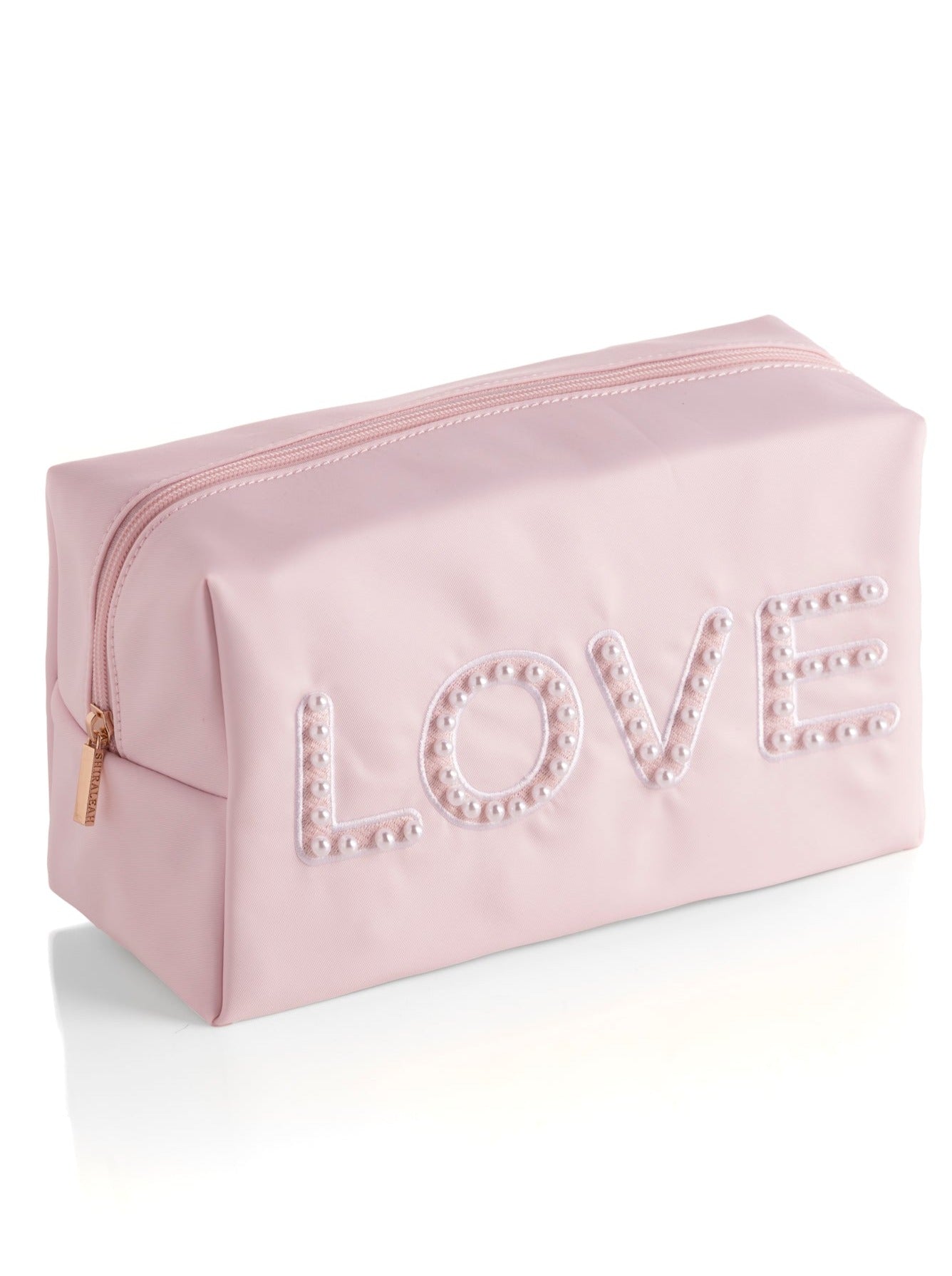 Carry all your odds and ends in style with Shiraleah's "Love" Zip Pouch. Made of durable polyester in light pink, this rectangular case is the perfect size to sit in a drawer or be carried on the go. The chic embroidered faux pearls spell out the word "Love" which make it the perfect pouch to take with you wherever you go. Pair with other items from Shiraleah to complete your look!