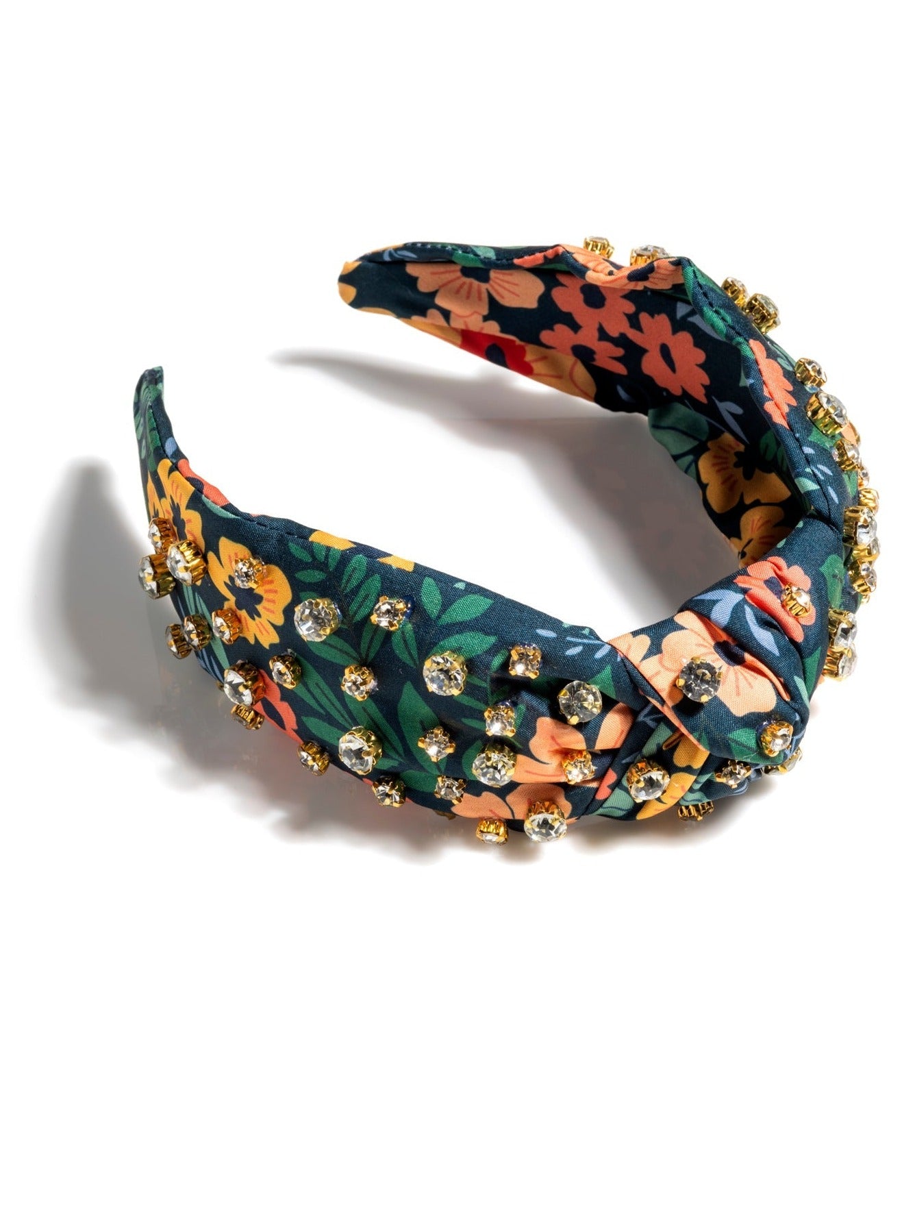 Add an elevated touch to your summer hairstyles with Shiraleah's Floral Embellished Knotted Headband. With its floral designs and rhinestone embellishments, this chic and intricate headband will be your new favorite summer accessory. Pair with other items from Shiraleah to complete your look!
