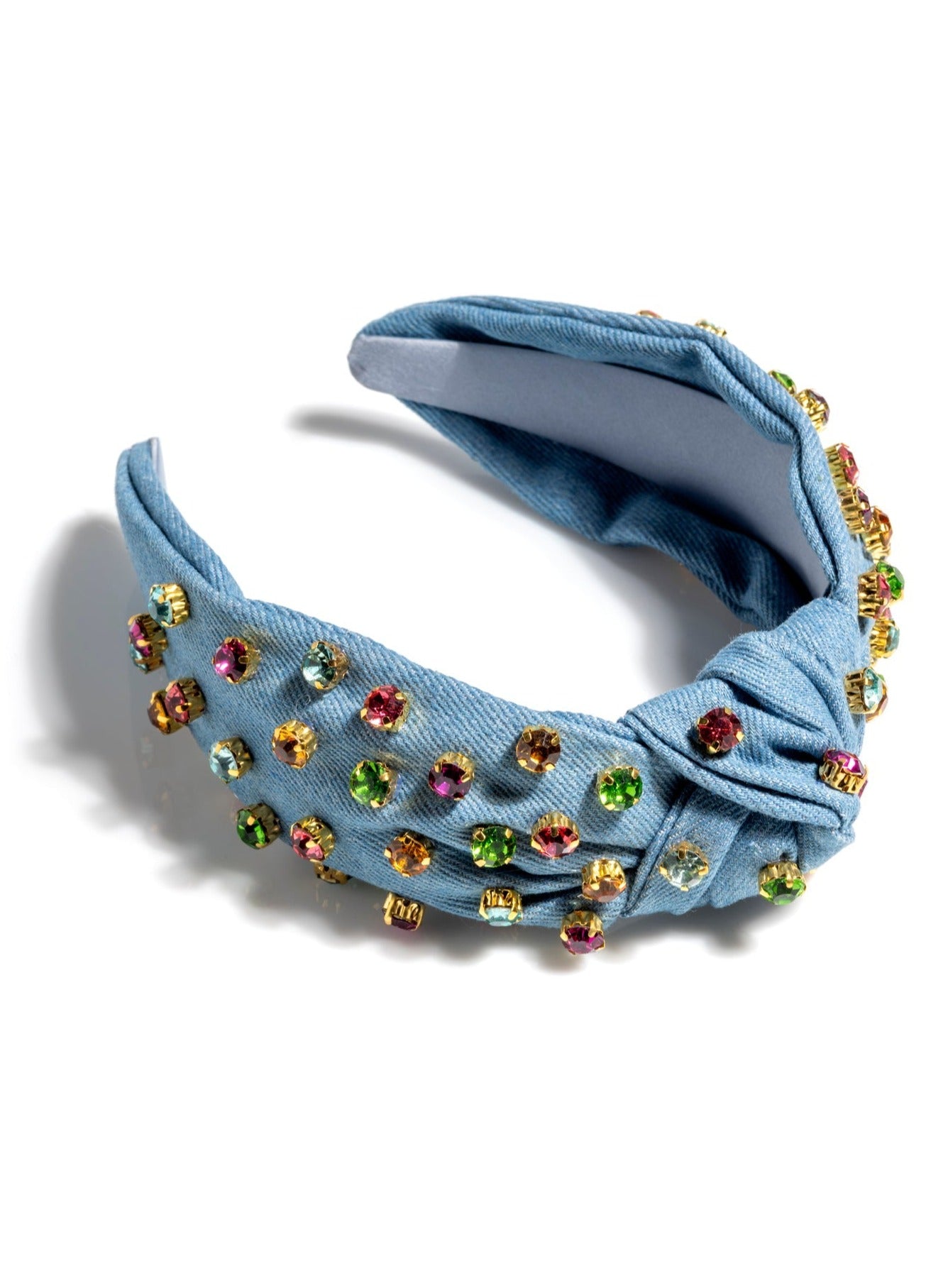 Add an elevated touch to your summer hairstyles with Shiraleah's Knotted Woven Headband. With its bright colored fabric, multicolored rhinestone embellishments, and sleek top knot detail, this elegant headband will be your new favorite summer accessory. Pair with other items from Shiraleah to complete your look!