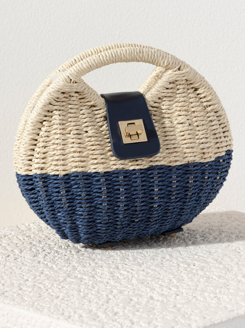 Add a classic touch to your outfit this summer with Shiraleah's Giorgia Cross Body Bag. Made from woven paper straw and durable PU, this bag is the perfect blend of today's trendiest accessories. The cutout top handle and detachable, adjustable cross-body strap allow for versatility in your style, and the secure turn-lock closure keeps all your items safe and secure. Pair with other items from Shiraleah's American Summer collection to complete your look!