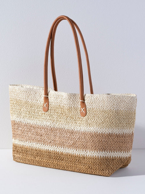
Ditch your boring beach bag this summer for Shiraleah's Formentera Tote. Made from woven paper straw with durable PU shoulder straps, this bag is your perfect companion to carry all your essentials in style. The elegant neutral stripe design makes this the perfect bag to match any warm weather outfit. Pair with the Formentera Zip Pouch and other items from Shiraleah to complete your look!