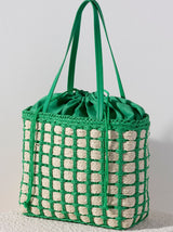 Accessorize with color this summer by carrying Shiraleah's Juanita Tote. Made from woven paper straw with a chic green cotton lining, this trendy bag will fit your favorite outfit perfectly. The drawstring closure ensures all your items are safely enclosed, while creating a unique silhouette that is sure to stand out from the crowd. Pair with other items from Shiraleah to complete your look!