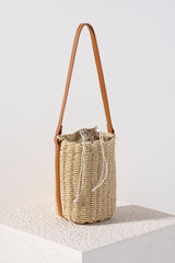 Keep all eyes on you this summer with Shiraleah's trendy and unique Jos Bucket Bag. Made from woven paper straw in a natural color, this neutral accessory will match any outfit seamlessly. The durable PU handle can be worn on the elbow or over the shoulder, and the trendy drawstring closure ensures all of your items are safely enclosed. Pair with other items from Shiraleah's American Summer collection to complete your look!
