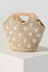 Add some sweetness to your summer accessories with Shiraleah's Hearts Mini Tote. Made from natural woven jute with a sturdy half-circle top handle, it is a classic neutral bag to go with any outfit or occasion. Its elegant beaded heart design will never go out of style. Pair with other Shiraleah items to complete your look!
