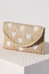 Add some sweetness to your summer accessories with Shiraleah's Hearts Clutch. Made from natural woven jute in a sleek clutch silhouette, it is a classic neutral bag to go with any outfit or occasion. Its elegant beaded heart design will never go out of style. Pair with other Shiraleah items to complete your look!
