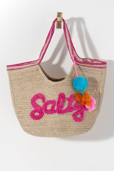 Bring some brightness to the beach with you this summer in Shiraleah's "Salty" Tote. Made from woven jute, the natural colored bag is accented with a pink top hem and pink lettering with the word "Salty" embroidered on the front. Big enough to carry all your essentials, it is the beach bag of your dreams. Pair with other items from Shiraleah to complete your look!
