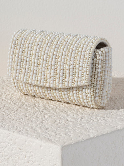 Show off your chicness this summer with Shiraleah's Danny Clutch. Its classic clutch silhouette is intricately embroidered with elegant white beads, making it a fun addition for every outfit. Featuring a detachable cross-body chain to add extra versatility to your style. Pair with other items from Shiraleah to complete your look!

