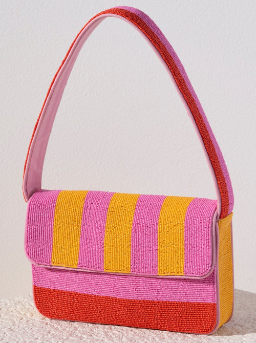 Everyday outfits just got more elegant with Shiraleah's Taylor Shoulder Bag. With its classic baguette silhouette, the purse's exterior is composed entirely of carefully embroidered glass beads. Its vibrant pink, orange, and yellow stripe design will give every outfit an extra pop of color. Pair with other items from Shiraleah to complete your look!