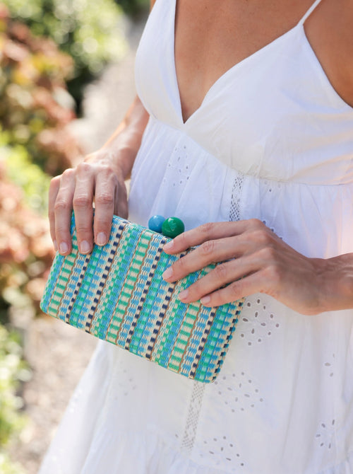 Add a pop of color to your summer outfits with Shiraleah's Positano Minaudiere. The richly textured fabric features a blue and green color scheme including two circular top clasps. You can carry it as a clutch, or use the detachable cross-body chain to create extra versatility in your style. Pair with other items from Shiraleah to complete your look!
