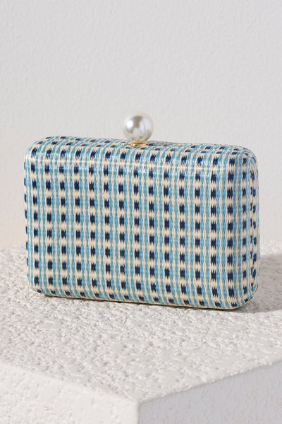 Let Shiraleah's Gemma Minaudiere be your something blue this summer. This classic rectangular purse features an elegant blue patterned fabric and a faux pearl top closure. You can carry it like a clutch or use the detachable cross-body chain for some extra versatility in your style. Pair with other items from Shiraleah's Hitched collection to complete your look!
