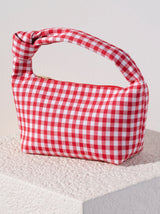 Add a pop of color to your outfit this summer with Shiraleah's Ami Knot Bag. Made from soft cotton in a classic red and white gingham design, this purse is perfect for a picnic or a night on the town. Pair with other items from Shiraleah to complete your look!
