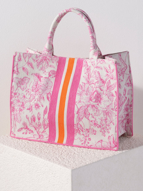 Carry your summer essentials in style with Shiraleah's Luma Tote. This soft but structured canvas bag features an elegant and feminine floral design, with a pink and orange racer stripe down the center. With its vibrant colors and durable body, this will be your favorite summer tote for years to come. Pair with other Shiraleah items to complete your look!
