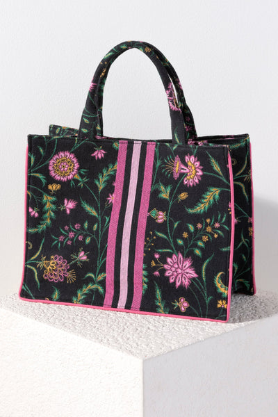 Carry your summer essentials in style with Shiraleah's Karla Tote. This soft but structured canvas bag features an elegant and feminine floral design, with a pink racer stripe down the center. With its vibrant colors and durable body, this will be your favorite summer tote for years to come. Pair with other Shiraleah items to complete your look!
