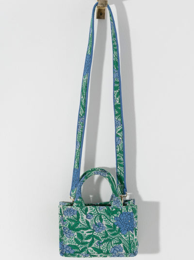 Carry your summer essentials in style with Shiraleah's Luma Mini Tote. This soft but structured canvas bag features a stylish green and blue floral design. With double handles and a matching detachable cross-body strap, there are endless ways to wear this purse. Pair with other Shiraleah items to complete your look!
