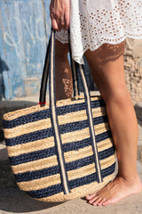 Carry your essentials in style this summer with Shiraleah's Port Tote. Made from woven jute with a chic blue striped pattern and red tassle detail, there is no better beach bag to bring with you on the go. Its sturdy double shoulder straps and roomy interior make it as practical as it is fashionable. Pair with other items from Shiraleah to complete your look!
