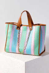 Elevate your summer style with Shiraleah's Jill Tote. This stunning tote is designed with a bright blue, green, and pink patterned fabric, complementing any outfit. With its spacious interior, it can effortlessly accommodate all your essentials, whether you're heading to the beach or the office. Pair with other items from Shiraleah to complete your look!