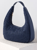 Carry all of your summer essentials in style with Shiraleah's Monroe Hobo. Made of elegant handwoven vegan leather, this purse is your new favorite summer handbag. Its single shoulder strap allows you to wear it easily over your arm. Pair with other items from Shiraleah to complete your look!
