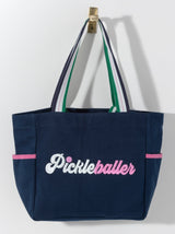 Stand out on the court with Shiraleah's "Pickleballer" Tote. Made from durable cotton canvas with multiple inner and outer pockets, you'll never leave an essential behind again. Whether you're a star player or just picking up on the trend, this is the perfect bag for the pickleballer in your life. Pair with other items from Shiraleah's Pickleball collection to complete your look!
