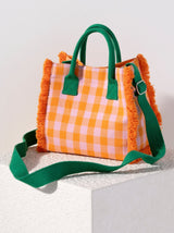 Put your bright personality on display with Shiraleah's Anna Mini Tote. Made from a bright gingham fabric with tufted edges, this compact purse is as practical as it is trendy. Add some versatility to your style with the detachable adjustable cross-body strap, or carry with its convenient top handles. Pair with other items from Shiraleah to complete your look!
