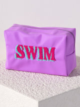 Carry all your odds and ends in style with Shiraleah's Joy "Swim" Zip Pouch. Made of durable polyester in a gentle lilac color, this rectangular case is the perfect size to carry your makeup or toiletries on the go. The trendy toothbrush embroidery spells the word "Swim" in pink and blue lettering, making it the perfect poolside companion. Pair with other items from Shiraleah to complete your look!
