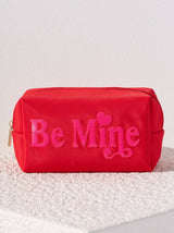 Carry all your odds and ends in style with Shiraleah's Cara "Be Mine" Zip Pouch. Made of durable polyester in a bright red color, this rectangular case is the perfect size to carry your makeup or toiletries on the go. The trendy pink sequin embroidery spells the words "Be Mine", adding a little love wherever you take it. Pair with other items from Shiraleah to complete your look!
