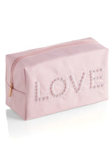 Carry all your odds and ends in style with Shiraleah's "Love" Zip Pouch. Made of durable polyester in light pink, this rectangular case is the perfect size to sit in a drawer or be carried on the go. The chic embroidered faux pearls spell out the word "Love" which make it the perfect pouch to take with you wherever you go. Pair with other items from Shiraleah to complete your look!
