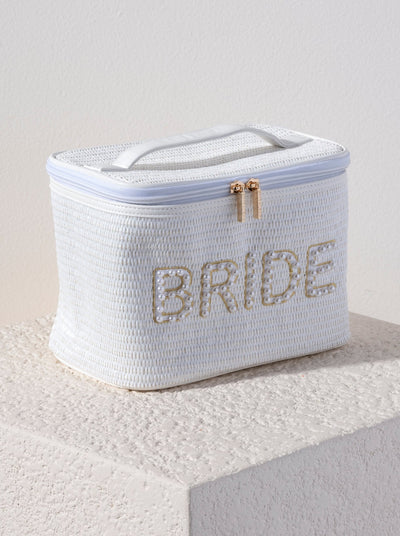 A rectangular cosmetic pouch with a top handle and a zip top opening, embroidered with the word 