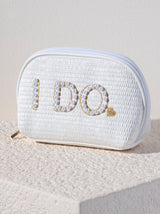 Carry all your cosmetic essentials for your big day in Shiraleah's "I Do" Zip Pouch. This chic top-zip pouch is embroidered with faux pearls and gold stitching and makes for the perfect cosmetic pouch for your honeymoon. Its woven white design matches the "Bride" Cosmetic Case. Pair with other items from Shiraleah's Hitched collection to complete your look!
