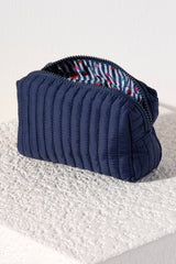Perfect your on-the-go lifestyle with Shiraleah's Ezra Small Boxy Cosmetic Pouch. This pouch features a quilted nylon body and a boxy silhouette, perfectly matching the material throughout Shiraleah's Ezra collection. This handy pouch is perfect for storing your makeup, toiletries or any odds and ends that you may need during travel or on a daily basis. Pair with other items from Shiraleah to complete your look!