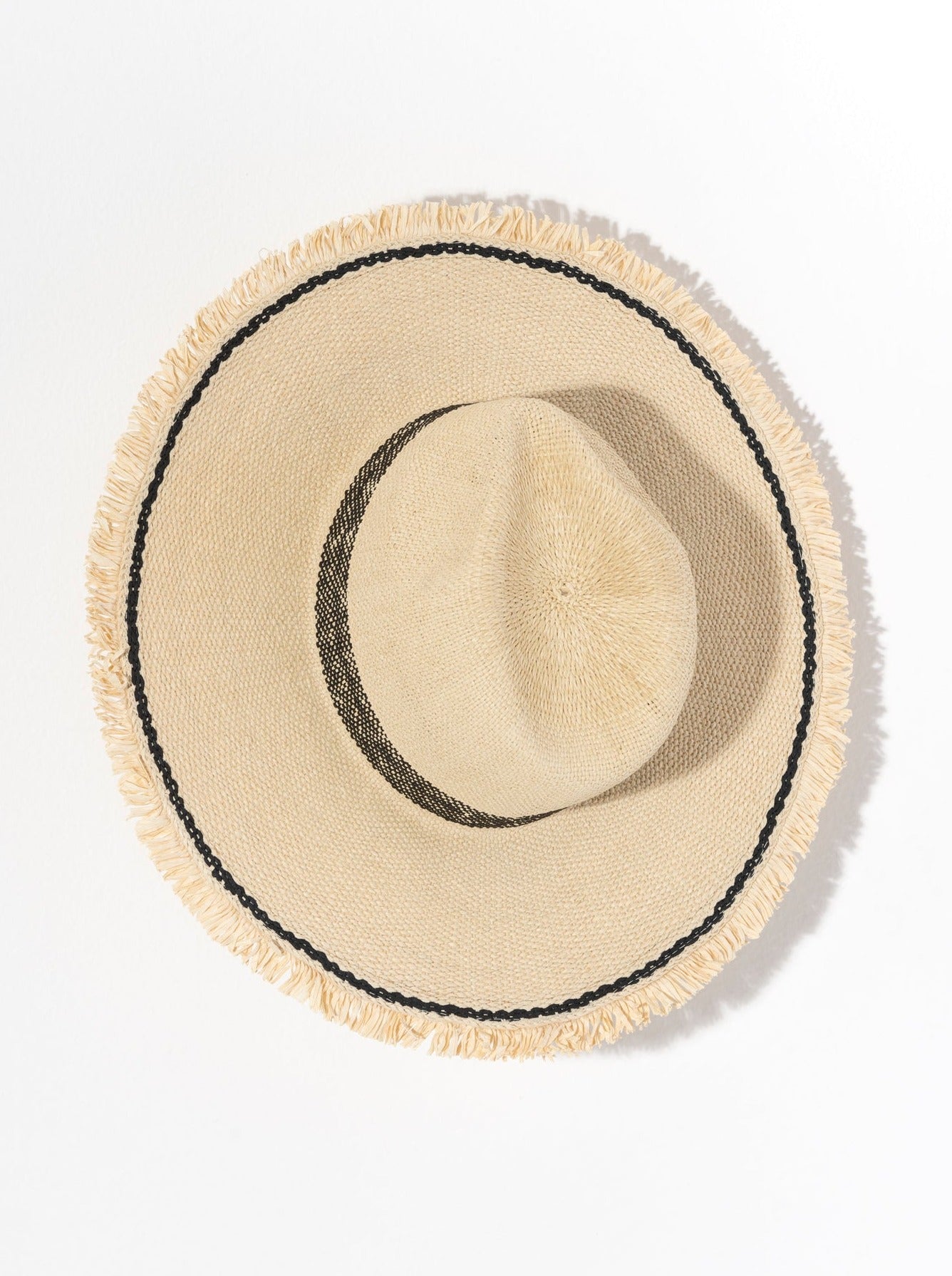 A woven straw hat with black lines around the center and by the hem