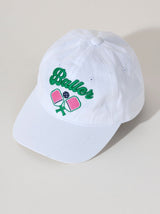 Stand out on the court with Shiraleah's "Baller" Hat. This bright white ball cap embroidered with green and pink letters is the perfect balance between sporty and trendy with its adorable embroidered pickleball paddles. Pair with other items from Shiraleah's Pickleball collection to complete your look!
