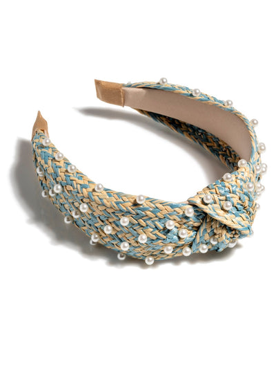 Add an elevated touch to your summer hairstyles with Shiraleah's Pearl Embellished Knotted Headband. With its classic braided straw design and faux pearl embellishments, this chic and feminine headband will be your new favorite summer accessory. Pair with other items from Shiraleah to complete your look!
