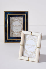 Put your favorite memories on display with Shiraleah’s Portofino Ribbed Picture Frame. With a chic ivoery color and gold trim, this 4x6 frame adds an elegant flair to your table top décor. The easel back stand allows the frame to sit easily on any flat surface display with a strong glass barrier to protect your artwork. Mix and match with other Shiraleah frames to complete your home gallery's look!
